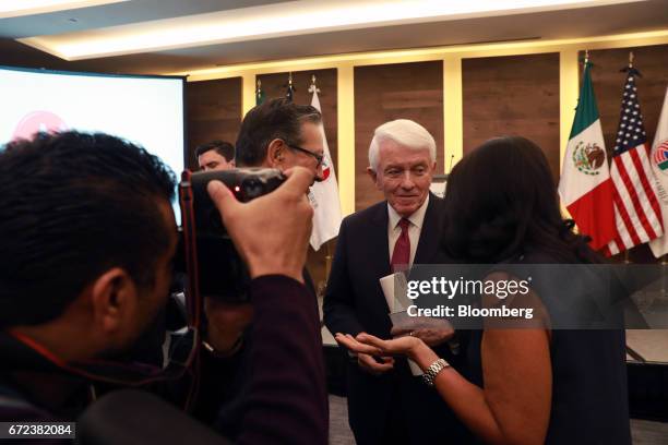 Thomas Donohue, president and chief executive officer of the U.S. Chamber of Commerce, center, speaks with an attendee during an event with the...