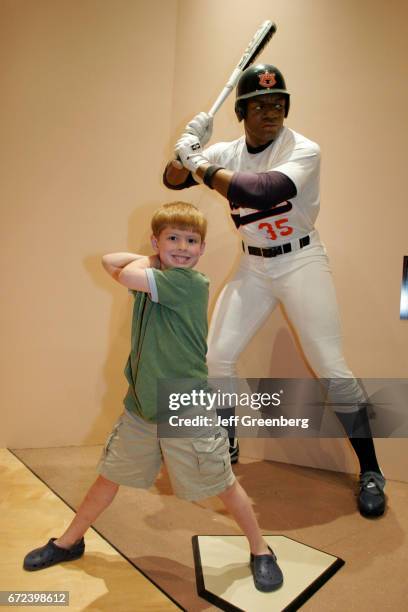 Boy posing next to a statue of Bo Jackson at the Lovelace Athletic Museum and Hall of Honor.