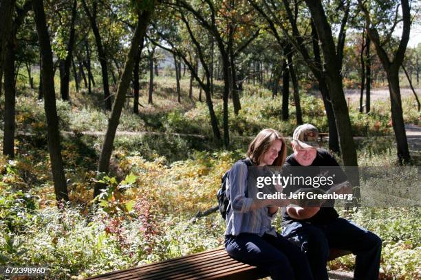 Couple looking at a book in Miller Woods at Indiana Dunes National Lakeshore.