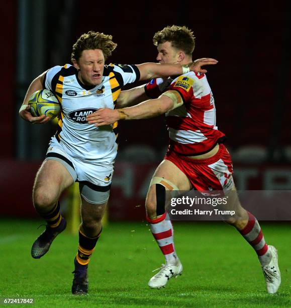 Tom Howe of Wasps A is tackled by Ollie Thorley of Gloucester United during the Aviva A League Semi Final match between Gloucester United and Wasps...