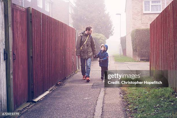 Father and son walking to school