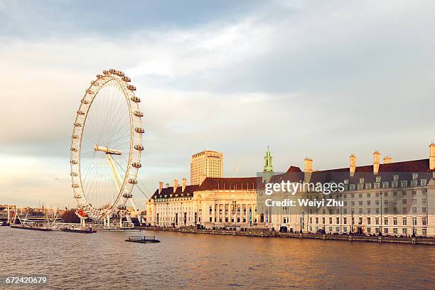 county hall with the london eye and river thames - london eye stock pictures, royalty-free photos & images