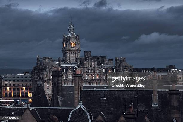 view of edinburgh under darkness - ominous clock stock pictures, royalty-free photos & images