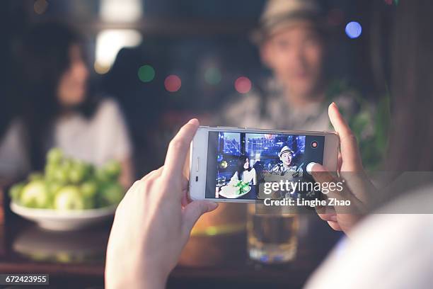 photographing friends at party - linghe zhao stock pictures, royalty-free photos & images