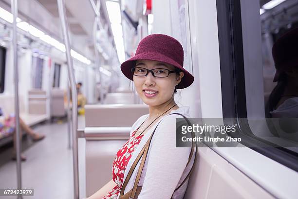 young asian woman in subway - linghe zhao stock pictures, royalty-free photos & images