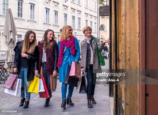 cheerful women shopping in town - old town spring shops stock pictures, royalty-free photos & images