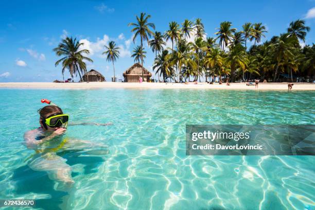 senior woman enjoying swiming with scuba mask near isla de perro island in caribbean see - caribbean sea stock pictures, royalty-free photos & images