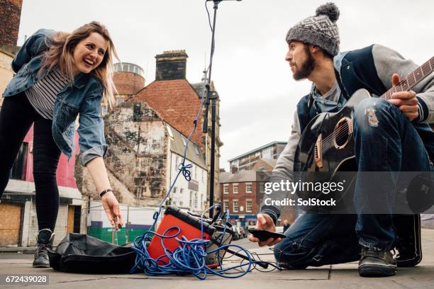 busking pays off! - street musician stock pictures, royalty-free photos & images