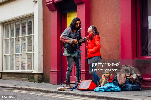 busking couple with dog - busker stock pictures, royalty-free photos & images