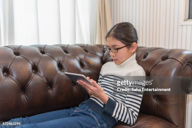 japanese girl using digital tablet - スマートフォン bildbanksfoton och bilder