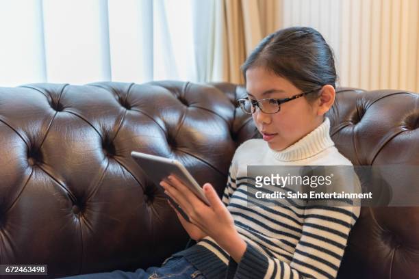 japanese girl using digital tablet - デジタルディスプレイ stock pictures, royalty-free photos & images