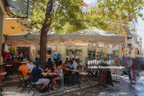 Athens, Attica, Greece, Cafe scene in the Plaka neighbourhood, Customers enjoying drinks and food at pavement tables.