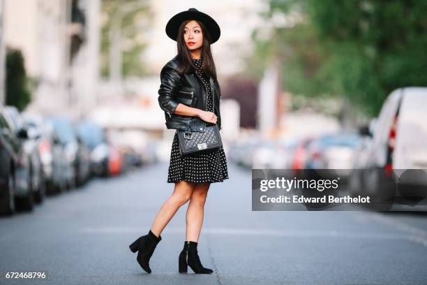 May Berthelot, fashion blogger and Head of Legal at Videdressing.com, wears a Newlook black dress with white prints, a Newlook black hat, Zara boots,...