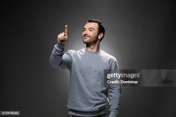 handsome young man showing something - man being pushed stock pictures, royalty-free photos & images