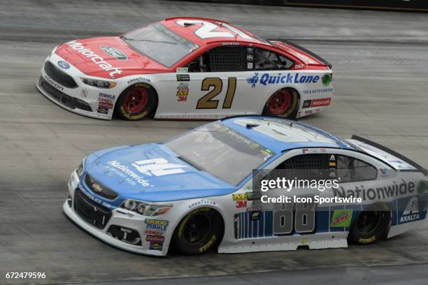 Dale Earnhardt, Jr. Nationwide Insurance Chevrolet SS and Ryan Blaney Wood Brothers Motorcraft/Quick Lane Ford Fusion race side by side during the...