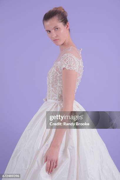 Model poses on seamless paper at the Isabelle Armstrong Spring 2018 bridal presentation during New York Fashion Week: Bridal April 2017 at The London...