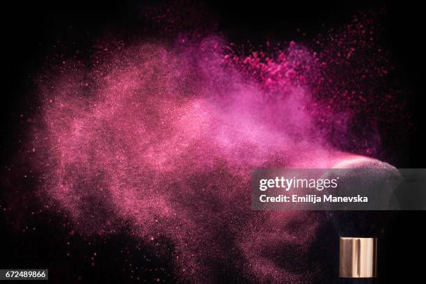 pink colored face powder exploding - gesichtspuder stock-fotos und bilder