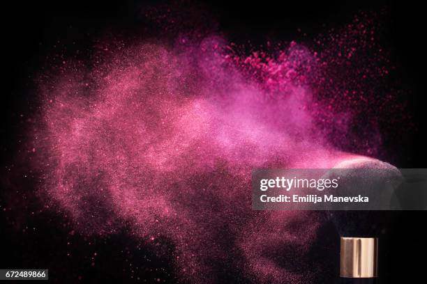 pink colored face powder exploding - make up powder stockfoto's en -beelden