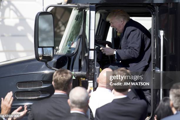 President Donald Trump sits in the drivers seat of a semi-truck as he welcomes truckers and CEOs to the White House in Washington, DC, March 23 to...