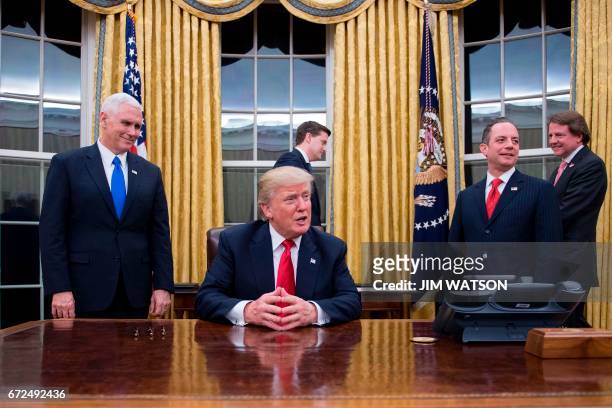 President Donald Trump speaks to the press as he waits at his desk before signing conformations for General James Mattis as US Secretary of Defense...