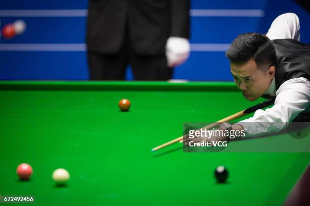 Marco Fu of Chinese Hong Kong plays a shot during his second round match against Neil Robertson of Australia on day ten of Betfred World Championship...