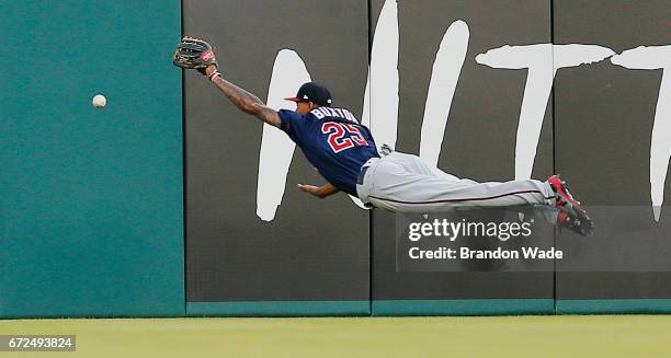 Center fielder Byron Buxton of the Minnesota Twins is unable to catch a ball off the bat of Mike Napoli of the Texas Rangers during the second inning...