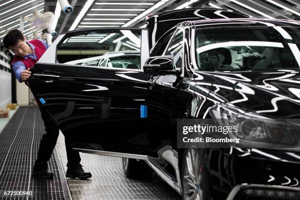 An employee performs final inspections on a Hyundai Motor Co. Genesis luxury sedan on the production line at the company's plant in Ulsan, South...