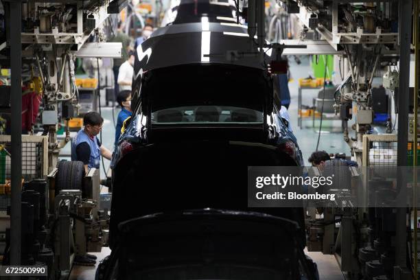 Employees assemble Hyundai Motor Co. Genesis luxury sedans on the production line at the company's plant in Ulsan, South Korea, on Monday, April 24,...