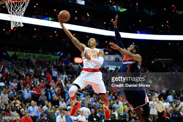 Kent Bazemore of the Atlanta Hawks goes up for a basket against John Wall of the Washington Wizards during the second quarter in Game Four of the...