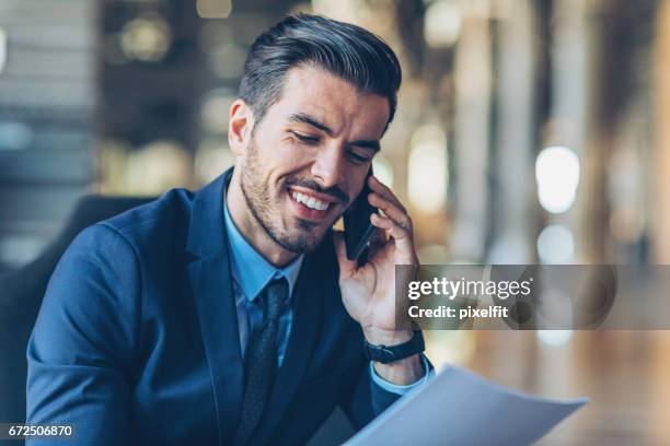 close-up of a smiling businessman with smart phone - legal expertise stock pictures, royalty-free photos & images