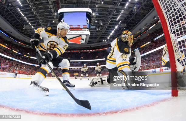 John-Michael Liles and Tuukka Rask of the Boston Bruins defend their net against the Ottawa Senators in Game Five of the Eastern Conference First...