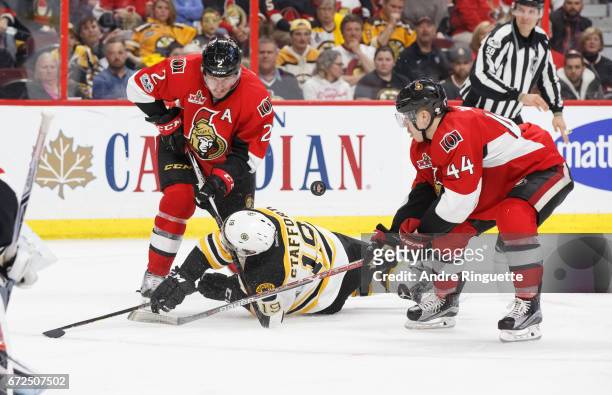 Dion Phaneuf and Jean-Gabriel Pageau of the Ottawa Senators knock Drew Stafford of the Boston Bruins off the puck in Game Five of the Eastern...