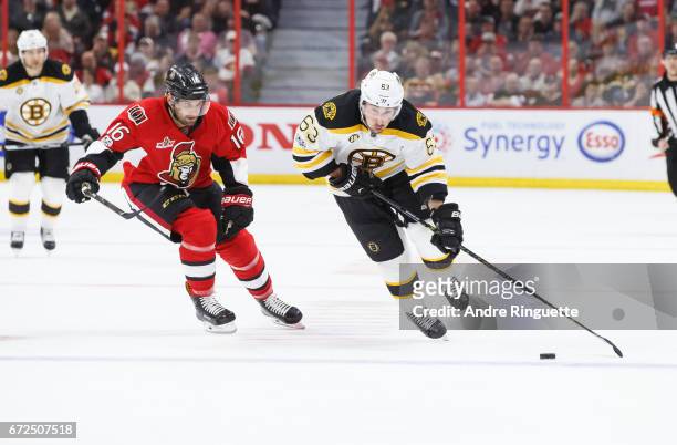 Brad Marchand of the Boston Bruins skates against Clarke MacArthur of the Ottawa Senators in Game Five of the Eastern Conference First Round during...