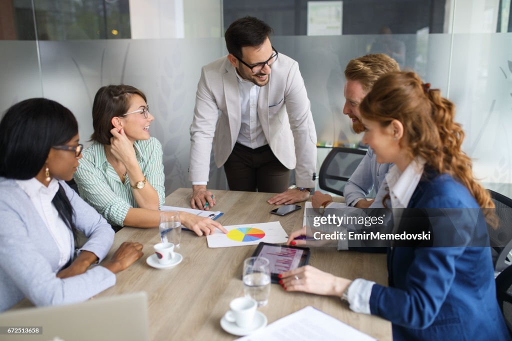 Young businessman discussing sale analysis with colleagues