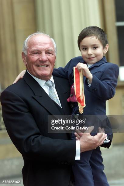 Boxer Sir Henry Cooper with his grandson after receiving a knighthood from the Queen at Buckingham Palace, London, 22nd Fenruary 2000.