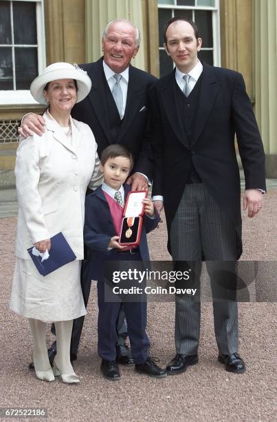 Boxer Sir Henry Cooper with his wife Albina, son and grandson after receiving a knighthood from the Queen at Buckingham Palace, London, 22nd Fenruary...