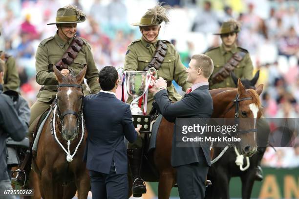 Mounted defence force soldiers deliver the Anzac Day match trophy to Anthony Minichiello and Ben Creagh before the round eight NRL match between the...