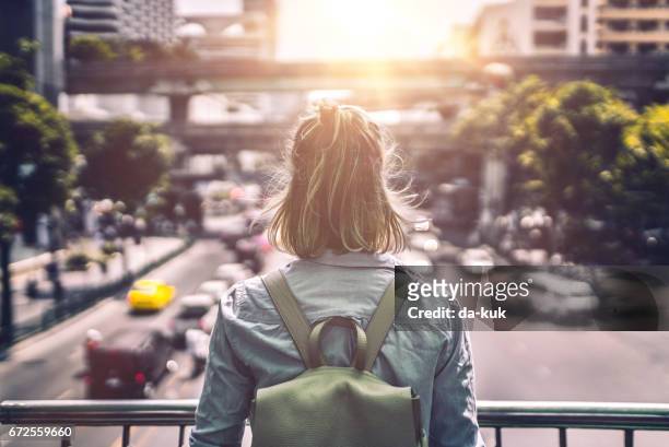 young woman exploring streets of bangkok - traffic jam aerial stock pictures, royalty-free photos & images