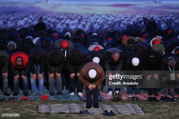 People perform prayer at Kocadere village camp area ahead of the loyalty march for 57th Infantry Regiment within the ceremony marking the 102nd...