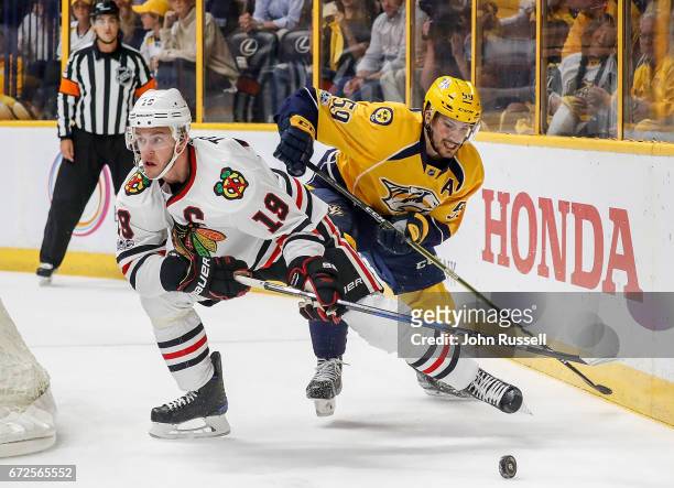 Roman Josi of the Nashville Predators battles against Jonathan Toews of the Chicago Blackhawks in Game Four of the Western Conference First Round...