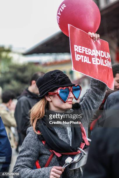 Demonstrators hold placards reading &quot;Referendum should be cancelled&quot; during a protest at the Kadikoy district in Istanbul on April 23, 2017...