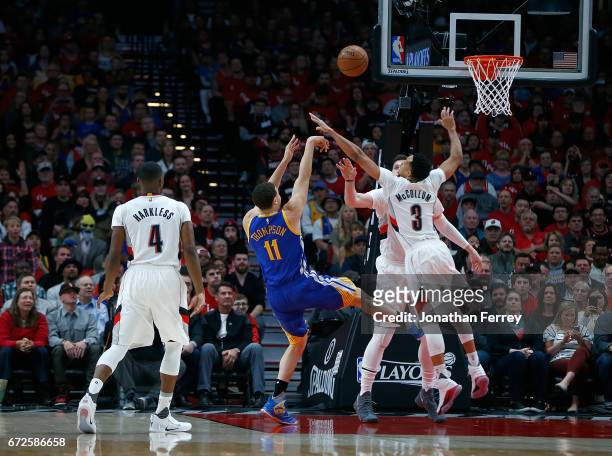 Klay Thompson of the Golden State Warriors shoots the ball over CJ McCollum of the Portland Trail Blazers during Game Three of the Western Conference...