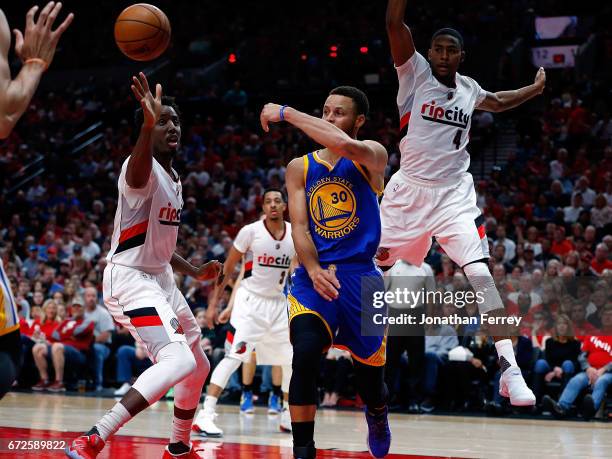 Stephen Curry of the Golden State Warriors passes the ball over Al Farouq Aminu of the Portland Trail Blazers during Game Three of the Western...