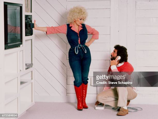 View of American musician and actress Dolly Parton and her agent Sandy Gallin at the latter's home, Los Angeles, California, 1984.