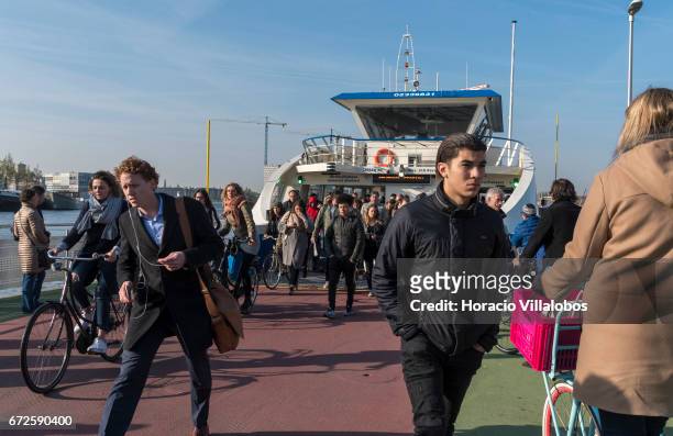 Passengers disembark from a ferry sailing from Central Station to NDSM on April 20, 2017 in Amsterdam, Netherlands. GVB ferries crisscross the city's...