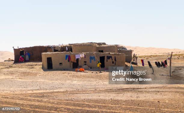 moroccan berber houses and berber women near sahara desert in morocco. - amazigh berber stock pictures, royalty-free photos & images