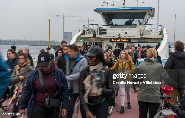 Passengers disembark from a ferry sailing from Central Station to NDSM on April 21, 2017 in Amsterdam, Netherlands. GVB ferries crisscross the city's...