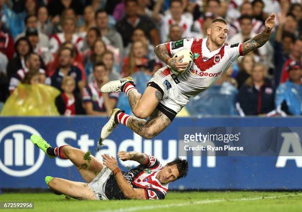 Josh Dugan of the Dragons is tackled by Mitchell Pearce of the Roosters in the in-goal area during the round eight NRL match between the Sydney...