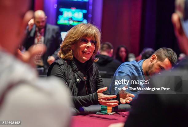 Jane Hitchcock author and writer from Georgetown, chats with her opponents while playing in a poker tournament at Maryland Live Casino on April 14,...