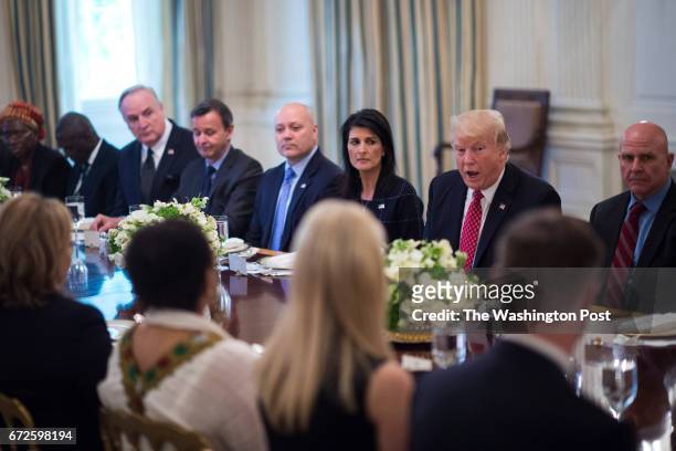 President Donald Trump, sitting next to U.S. Ambassador to the UN Nikki Haley, speaks during a working lunch with ambassadors of countries on the...